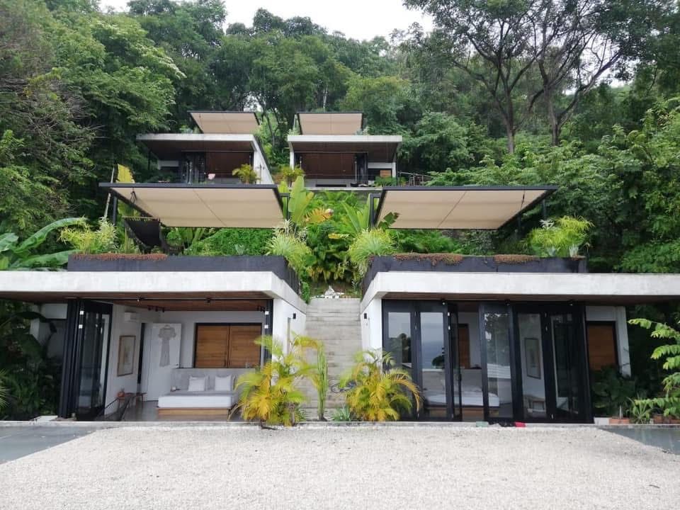 Hotel Mint — stacked pavilions with green roofs integrated into the Santa Teresa jungle.