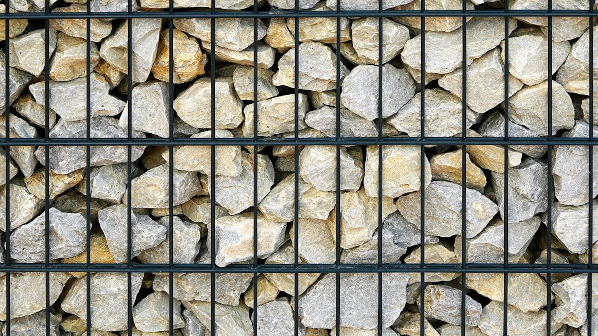 Reference image of a gabion wall with local stone — real photos of Matta Ruiz gabion builds coming soon.